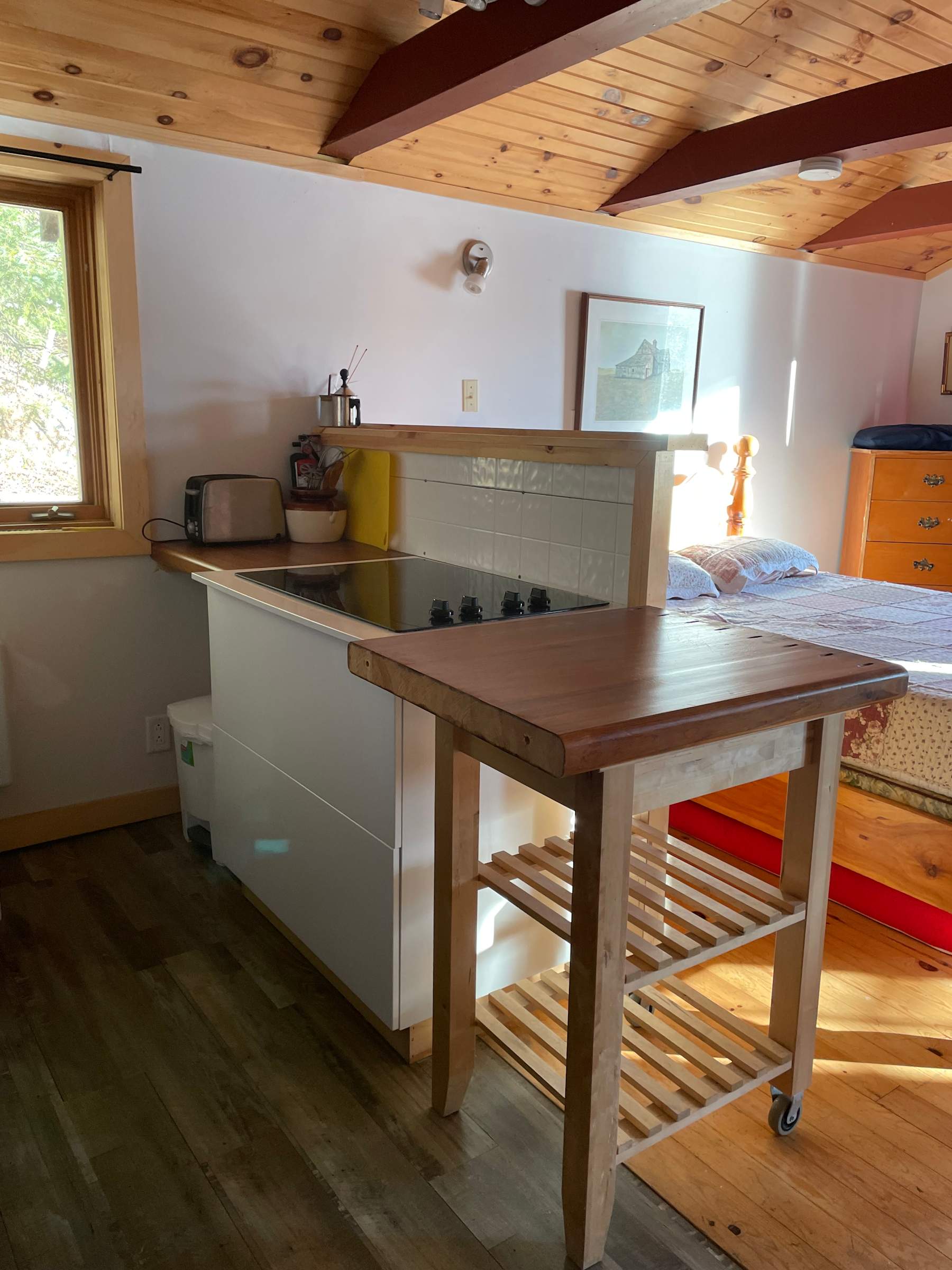 Open cottage kitchen with a wood worktop and natural light